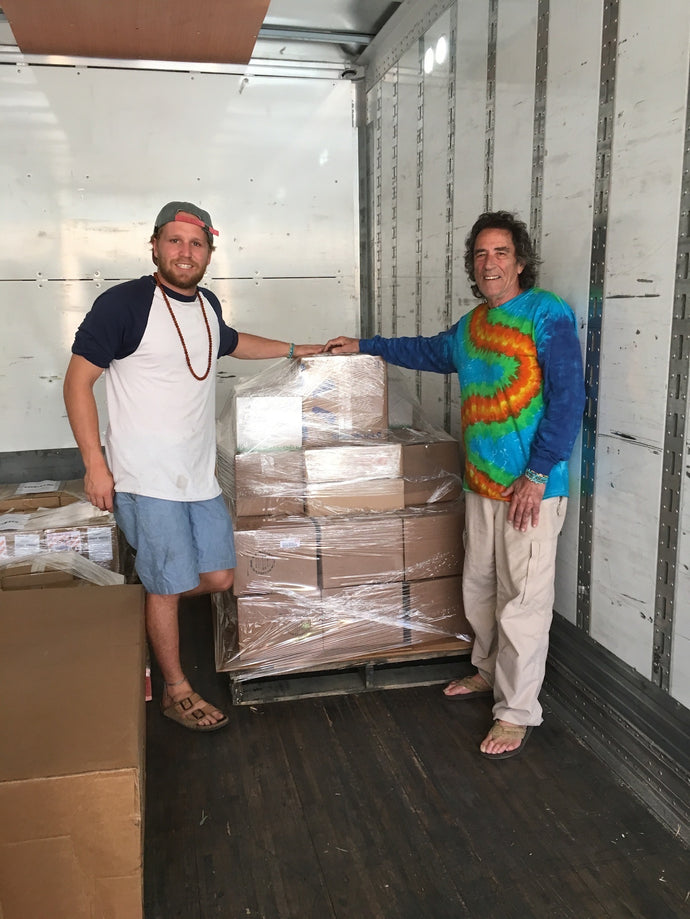 Founders Caleb and Richard pose in front of the first full pallet of Suzie's treats that was shipped. 